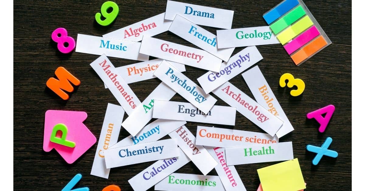 pieces of paper with school subjects listed like algebra, English, chemistry