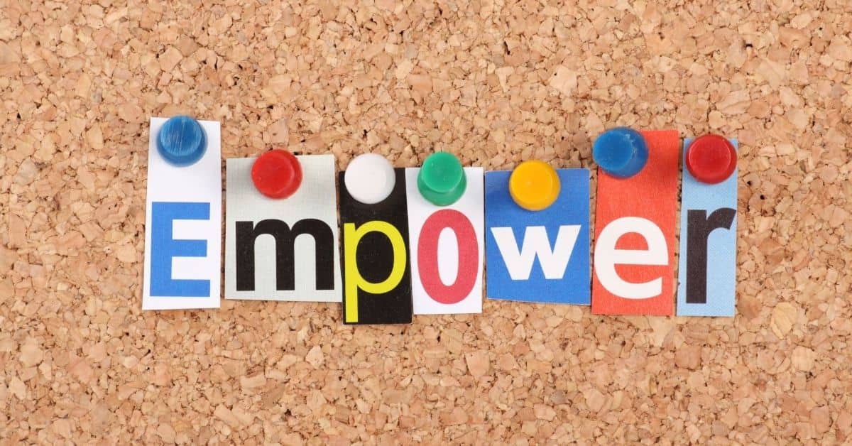 pieces of paper on a bulletin board spell empower